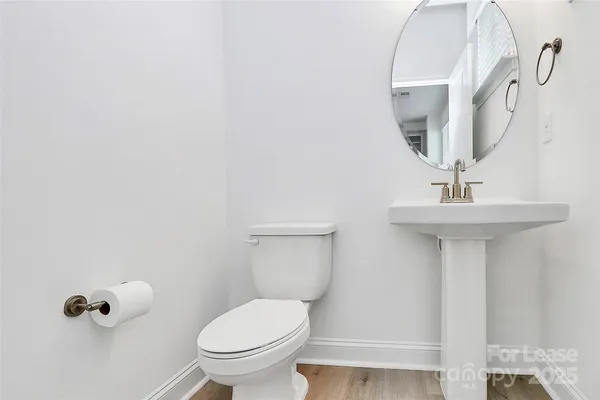 a bathroom with a sink toilet and a mirror