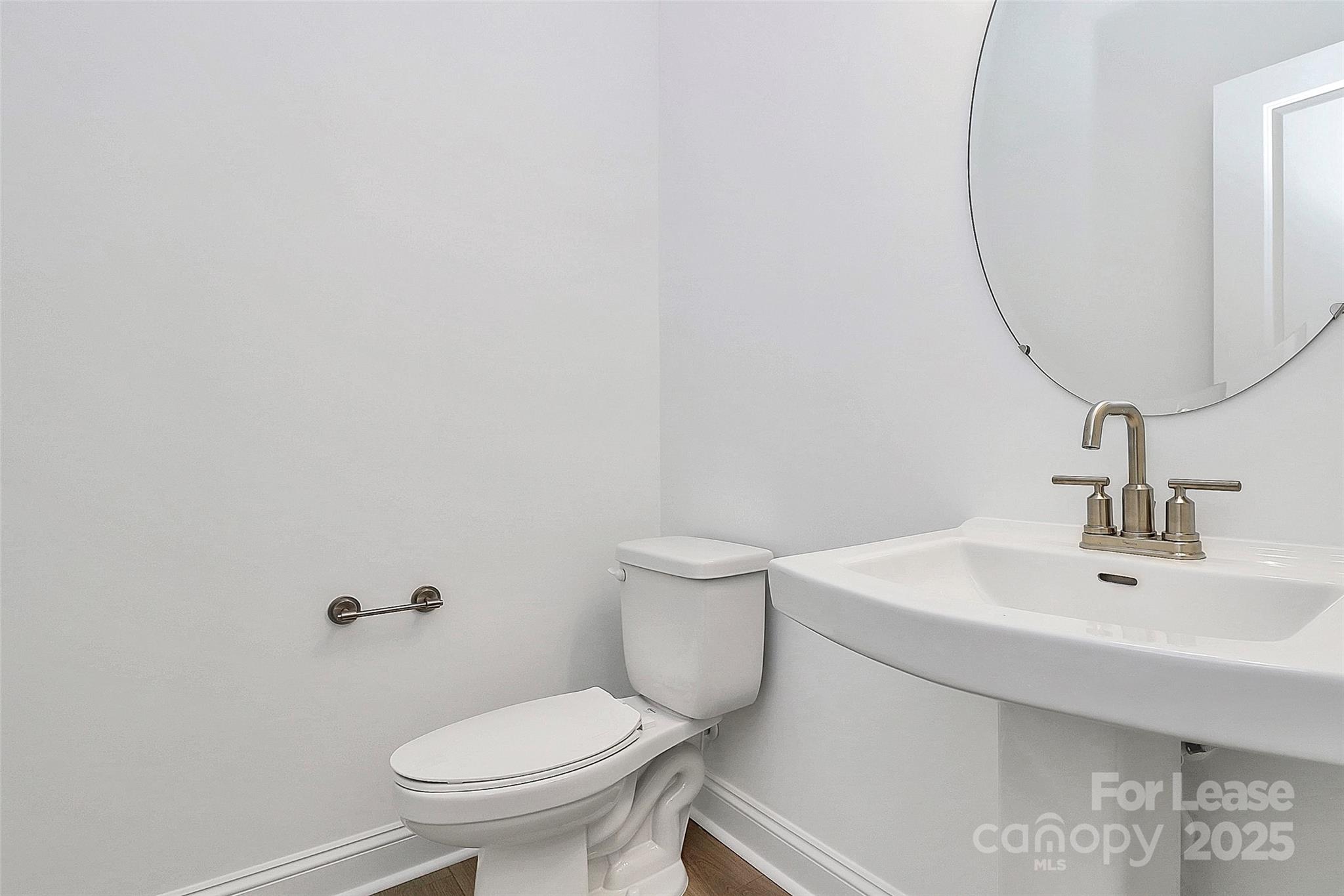 707 Hoke Lane Davidson, NC 28036 - Photo 5 of 27 a bathroom with a sink a toilet and a mirror