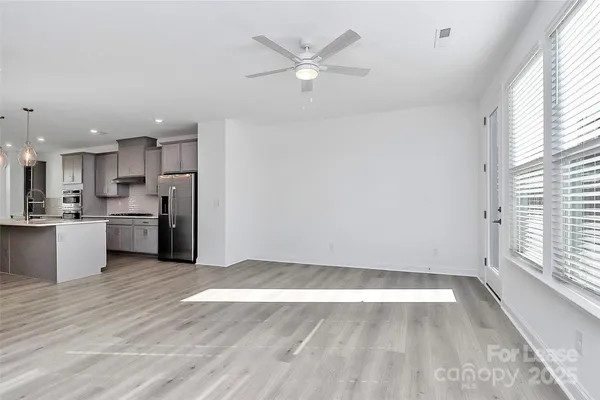 a view of kitchen with wooden floor and window