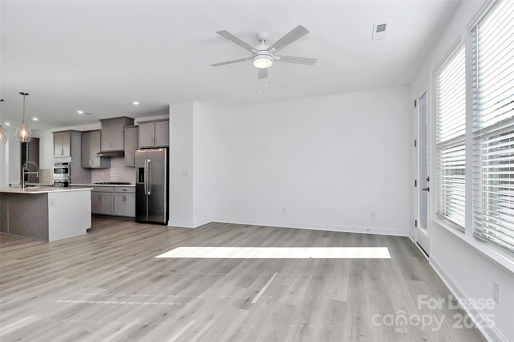 707 Hoke Lane Davidson, NC 28036 - Photo 6 of 27 a view of kitchen with wooden floor and window