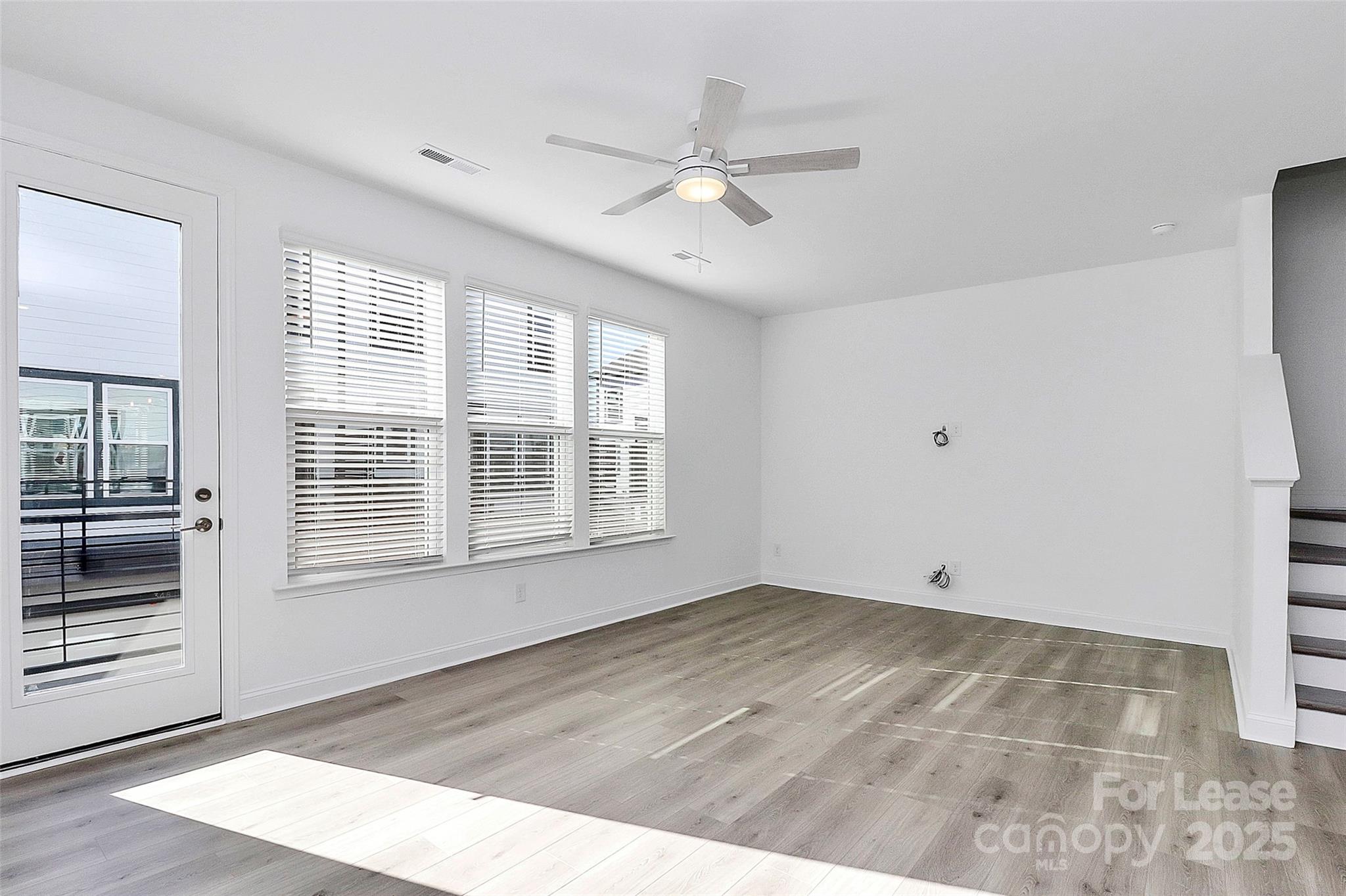 707 Hoke Lane Davidson, NC 28036 - Photo 7 of 27 a view of an empty room with wooden floor and a window