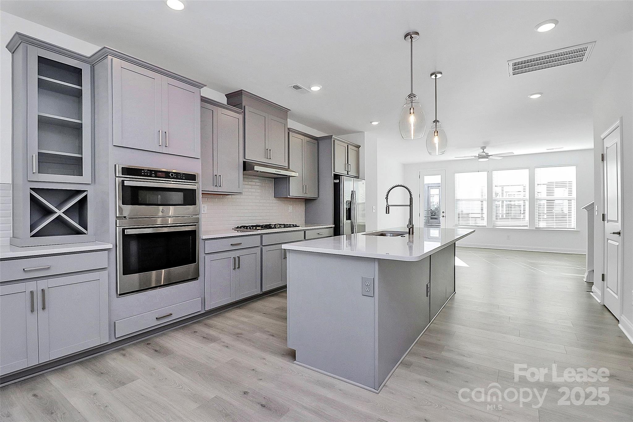 707 Hoke Lane Davidson, NC 28036 - Photo 9 of 27 a kitchen with a sink stainless steel appliances and cabinets