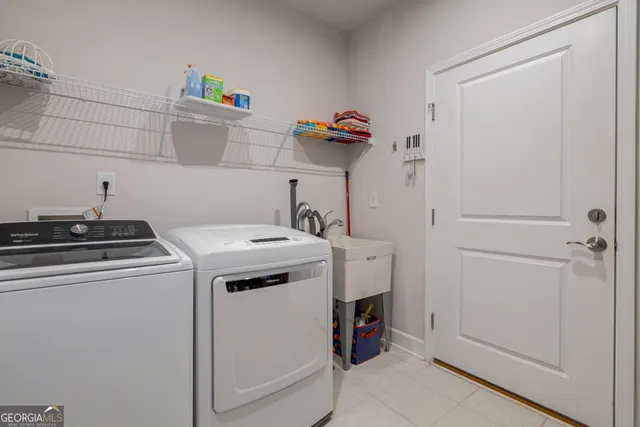 an aerial view of a house with swimming pool and large trees