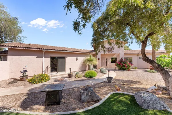 a living room with furniture a flat screen tv and a large window