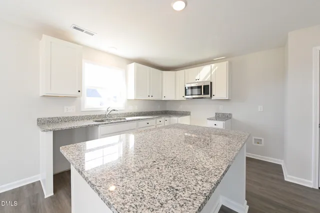 a kitchen with a stove a sink and a microwave