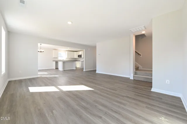 a view of a kitchen with wooden floor and a sink
