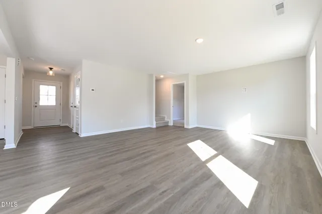 a view of an empty room and wooden floor