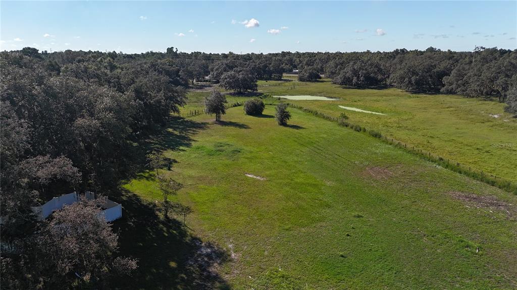 12510 Robinhood Road Hudson, FL 34669 - Photo 11 of 30 a view of a lake with huge green field and lots of trees