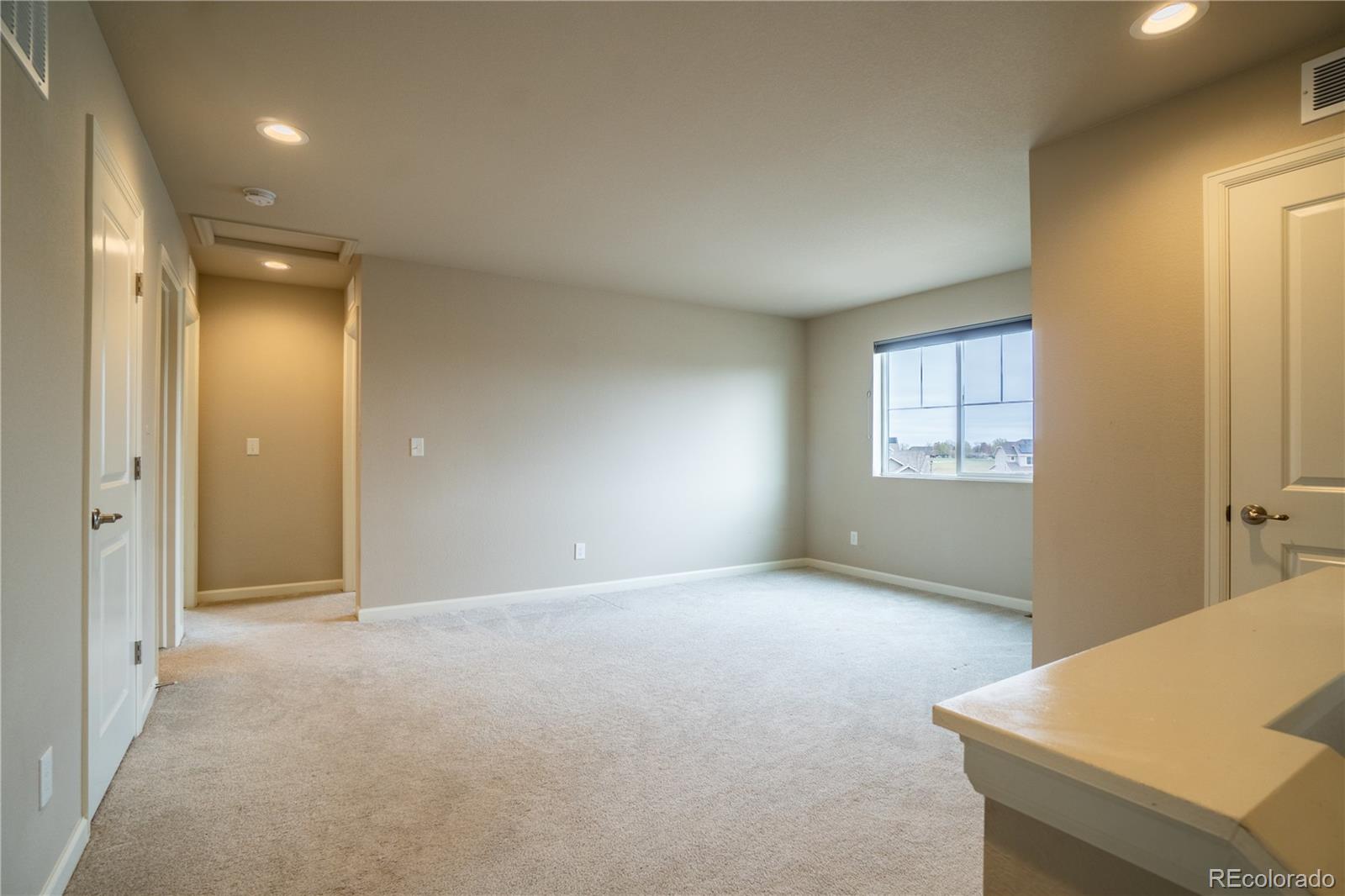 643 Ranchhand Drive Berthoud, CO 80513 - Photo 13 of 39 an empty room with windows