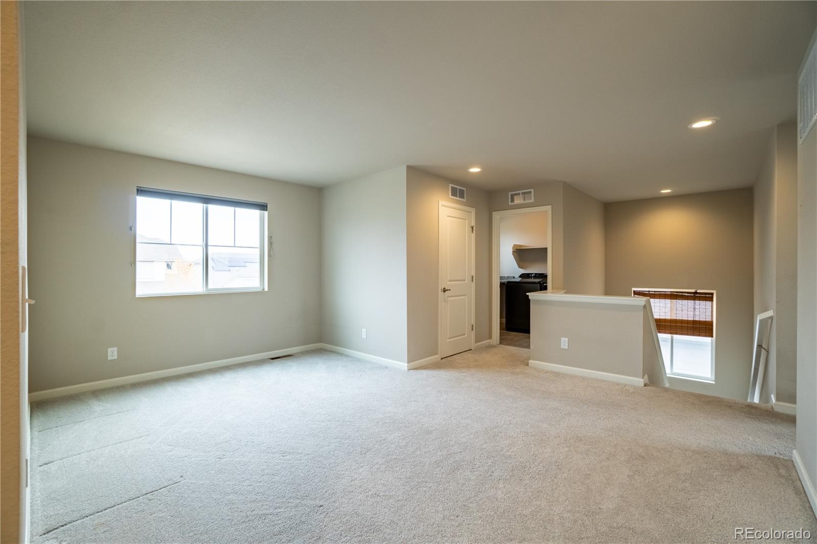 643 Ranchhand Drive Berthoud, CO 80513 - Photo 14 of 39 an empty room with a kitchen and a window