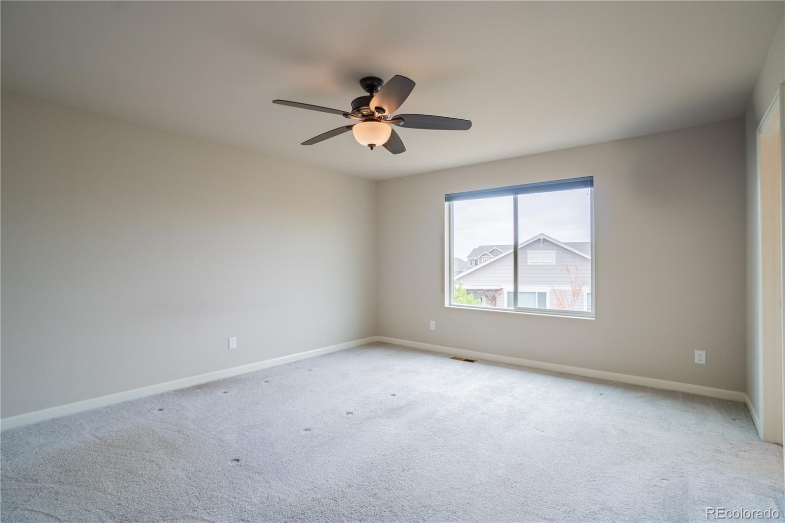 643 Ranchhand Drive Berthoud, CO 80513 - Photo 18 of 39 an empty room with windows and fan