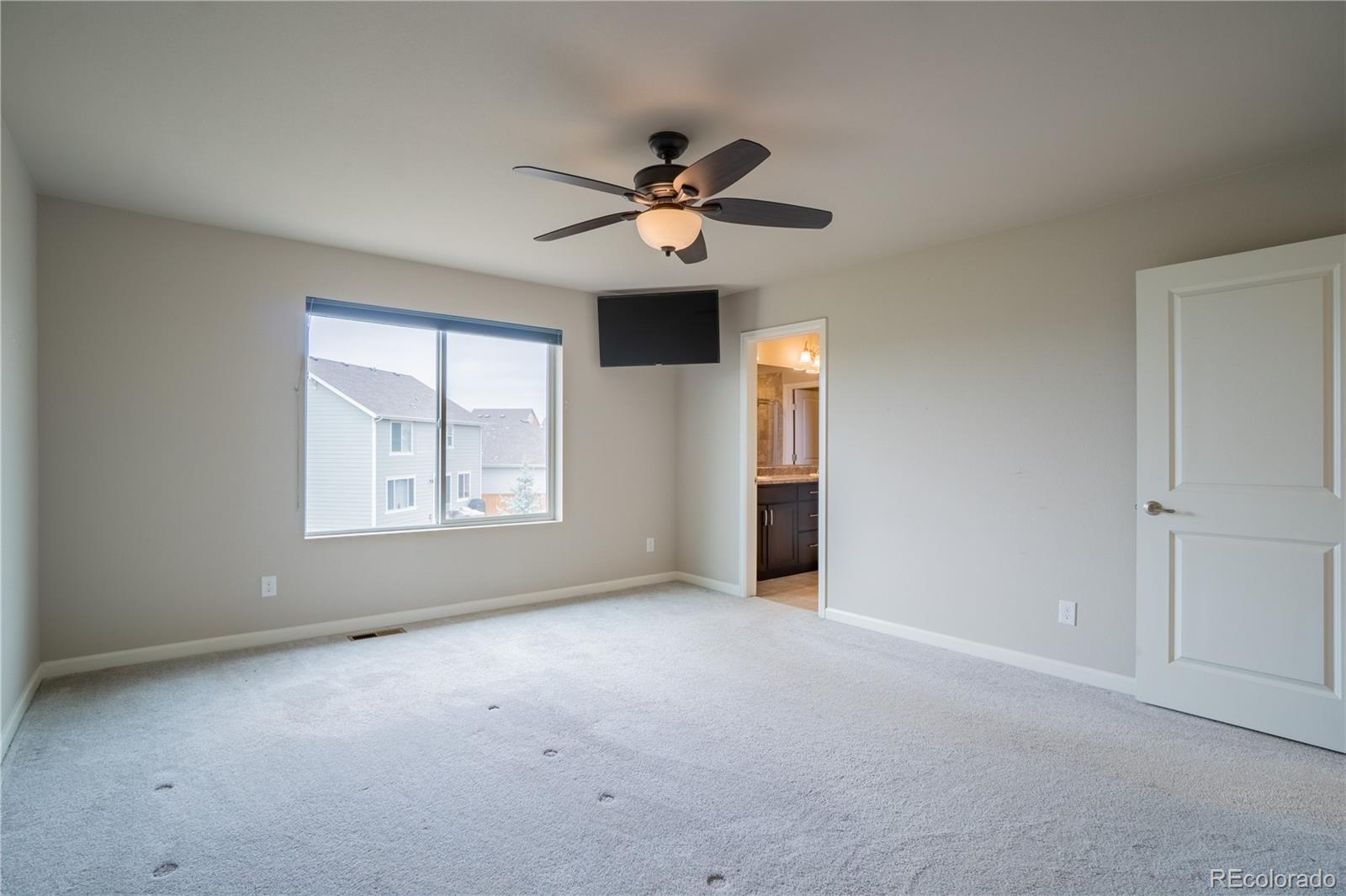 643 Ranchhand Drive Berthoud, CO 80513 - Photo 19 of 39 a view of a livingroom with a ceiling fan and window