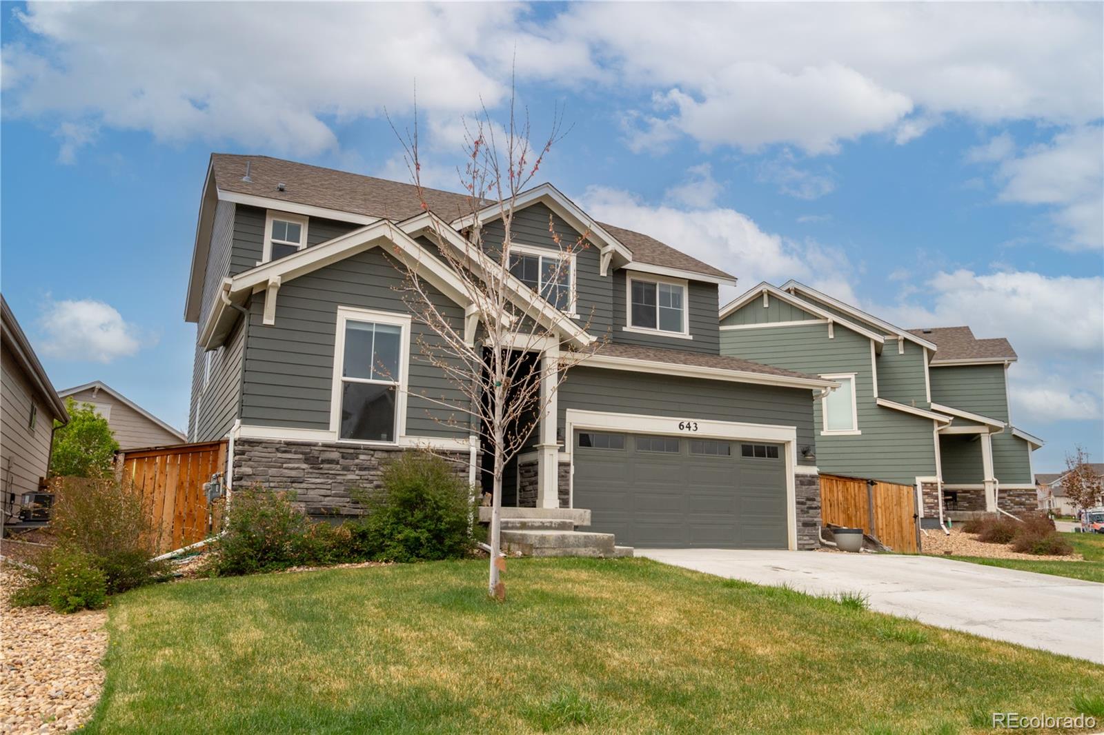 643 Ranchhand Drive Berthoud, CO 80513 - Photo 2 of 39 a front view of a house with a yard and garage