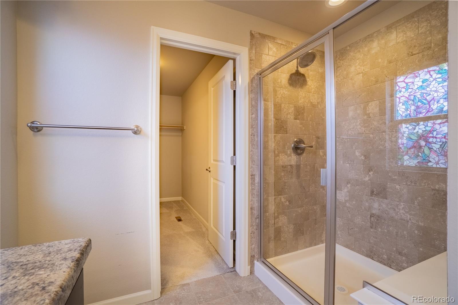 643 Ranchhand Drive Berthoud, CO 80513 - Photo 22 of 39 a bathroom with a shower and a glass door