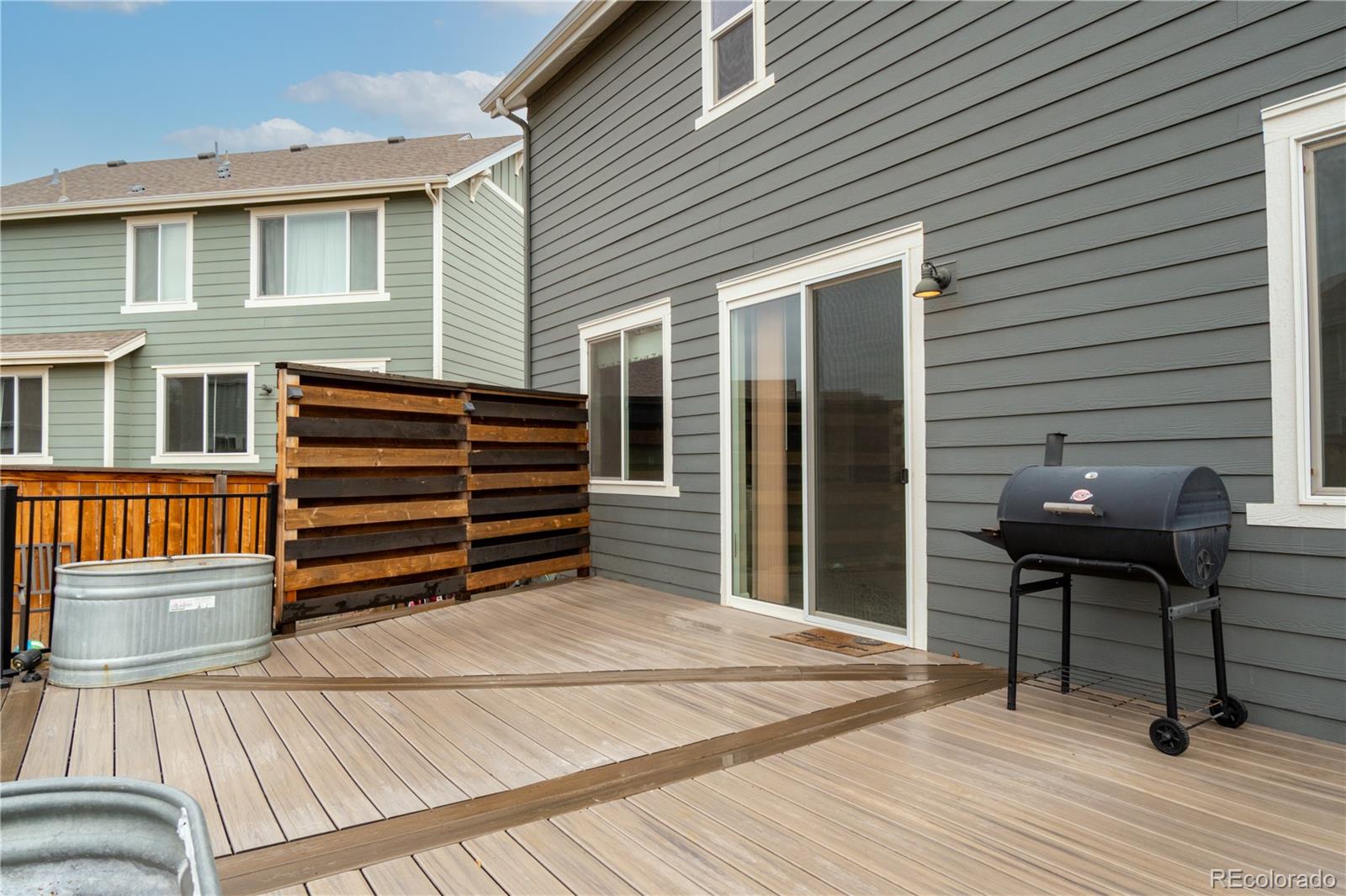 643 Ranchhand Drive Berthoud, CO 80513 - Photo 37 of 39 a backyard of a house with barbeque oven and outdoor seating