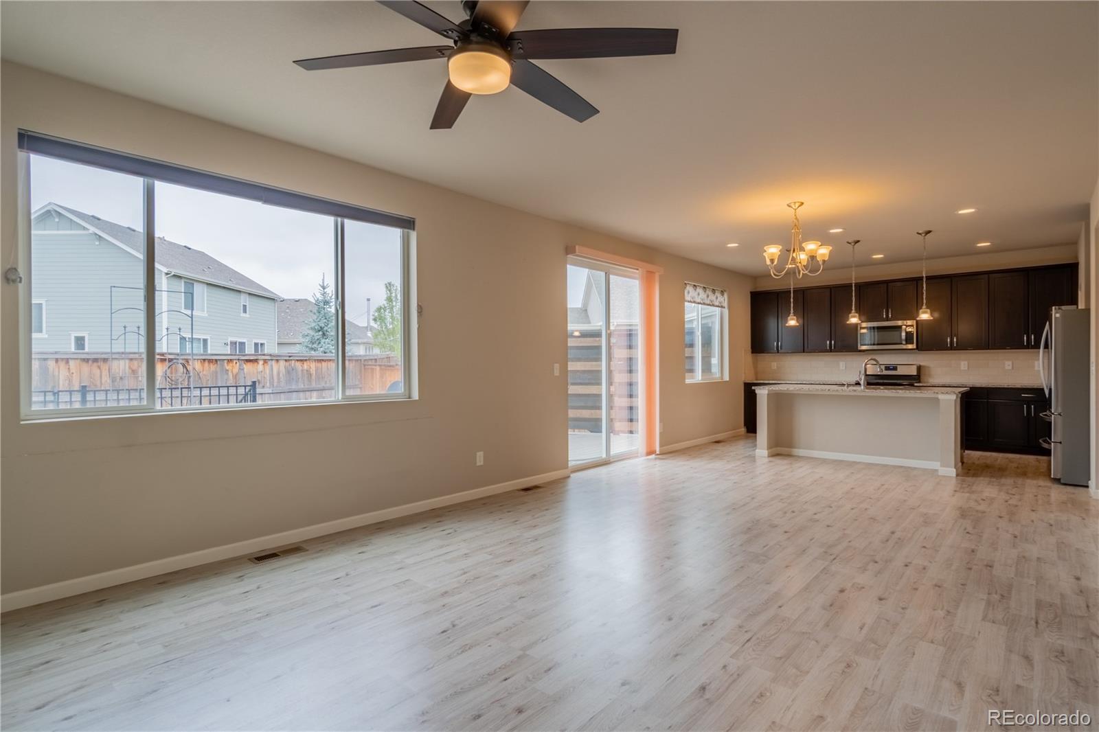 643 Ranchhand Drive Berthoud, CO 80513 - Photo 5 of 39 a view of an empty room with kitchen and window
