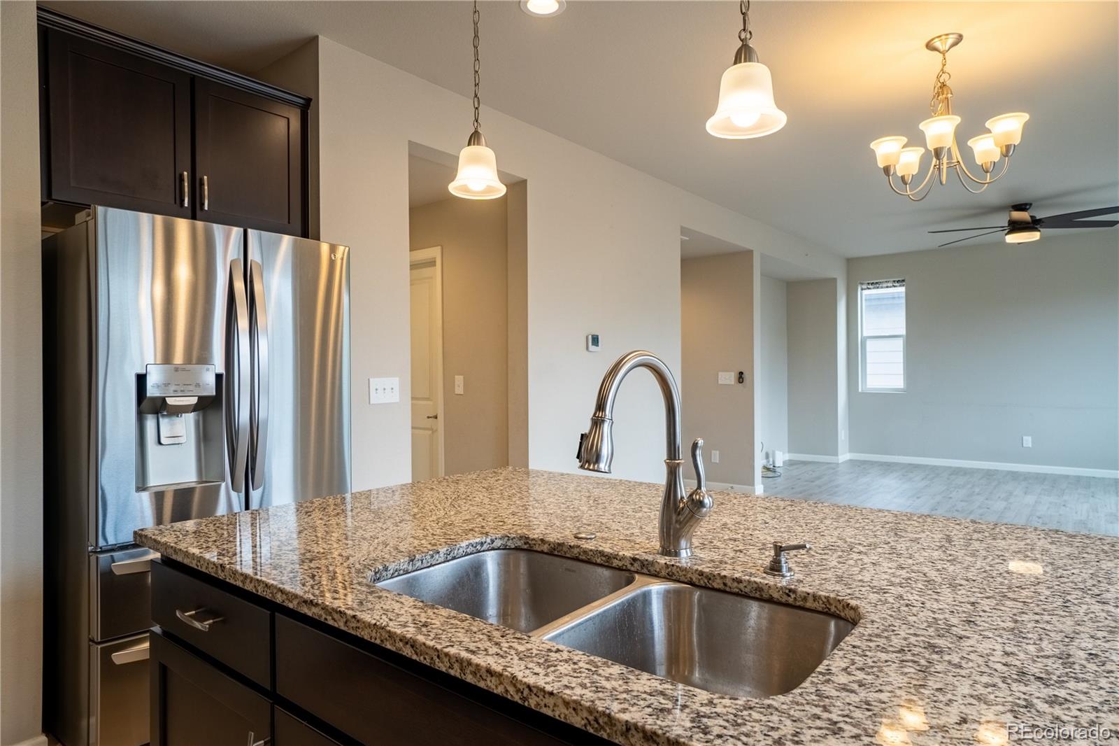643 Ranchhand Drive Berthoud, CO 80513 - Photo 10 of 39 a kitchen with a sink a counter space and a refrigerator