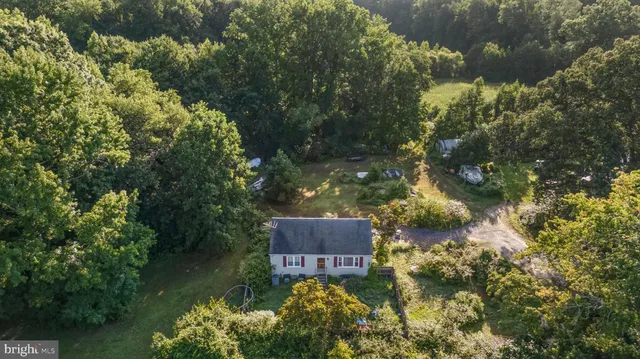 an aerial view of a house with a yard