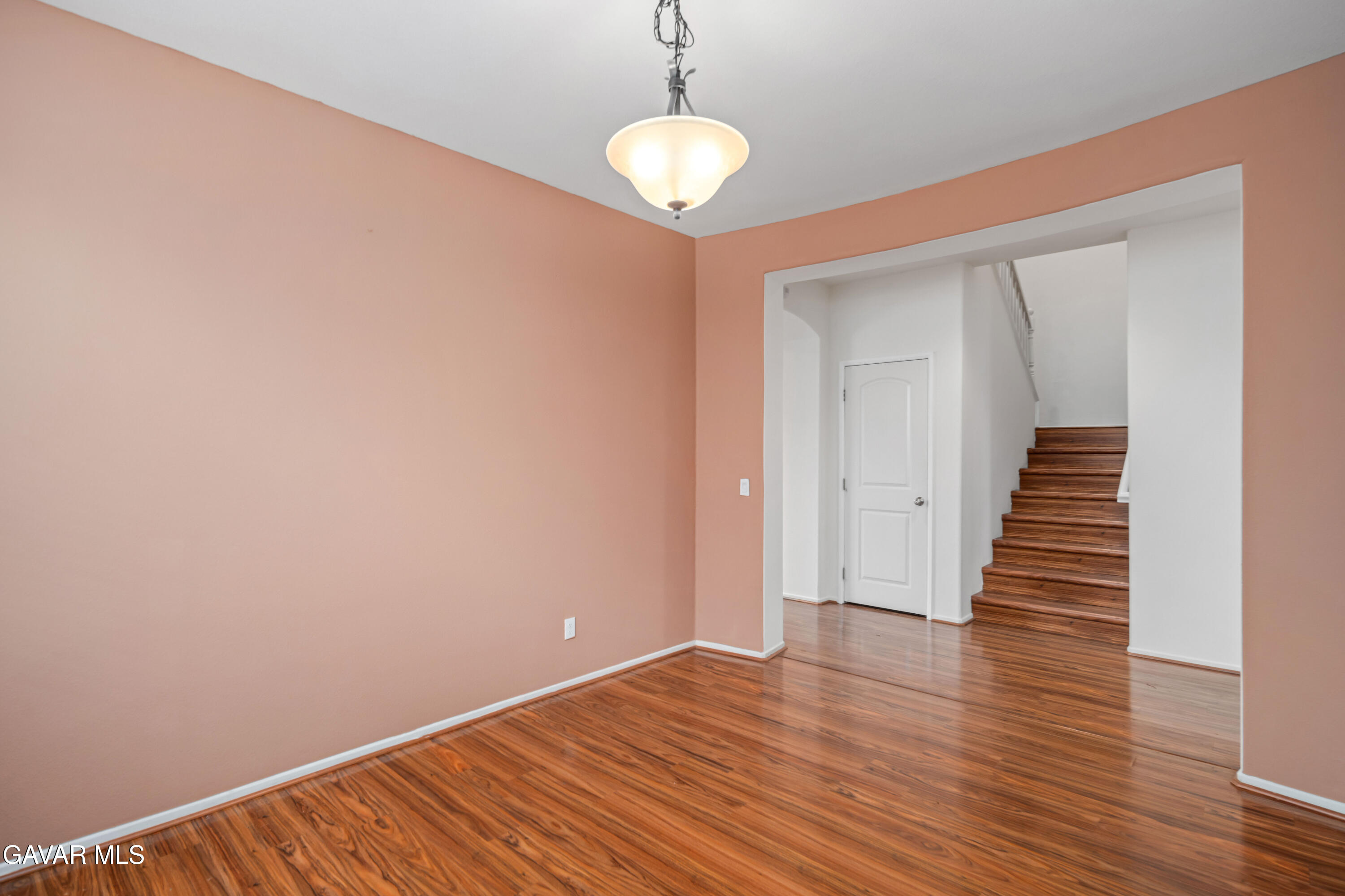 3024 Erica Avenue Rosamond, CA 93560 - Photo 12 of 32 a view of a room with wooden floor and staircase