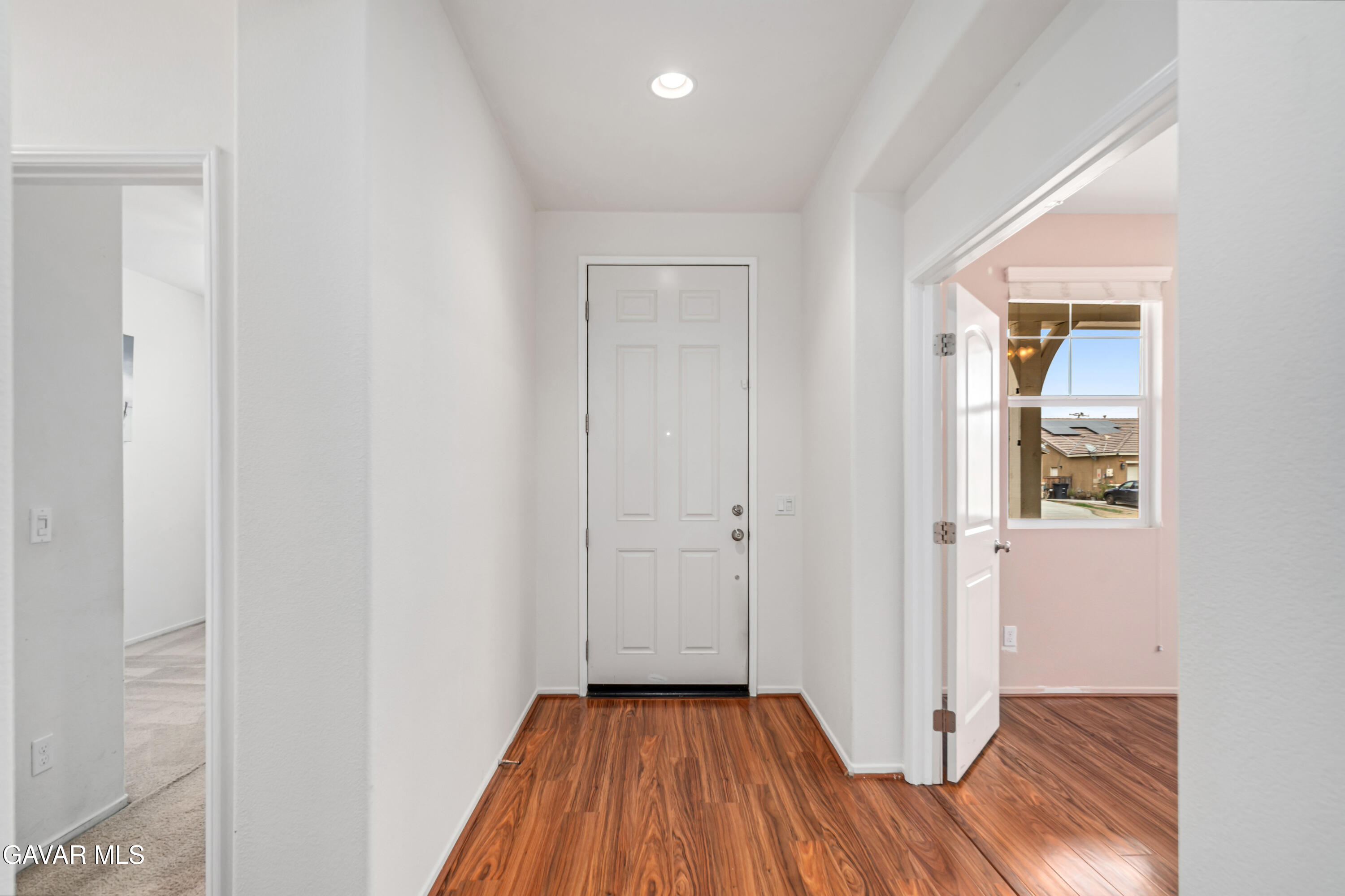 3024 Erica Avenue Rosamond, CA 93560 - Photo 13 of 32 a view of a hallway with wooden floor and closet