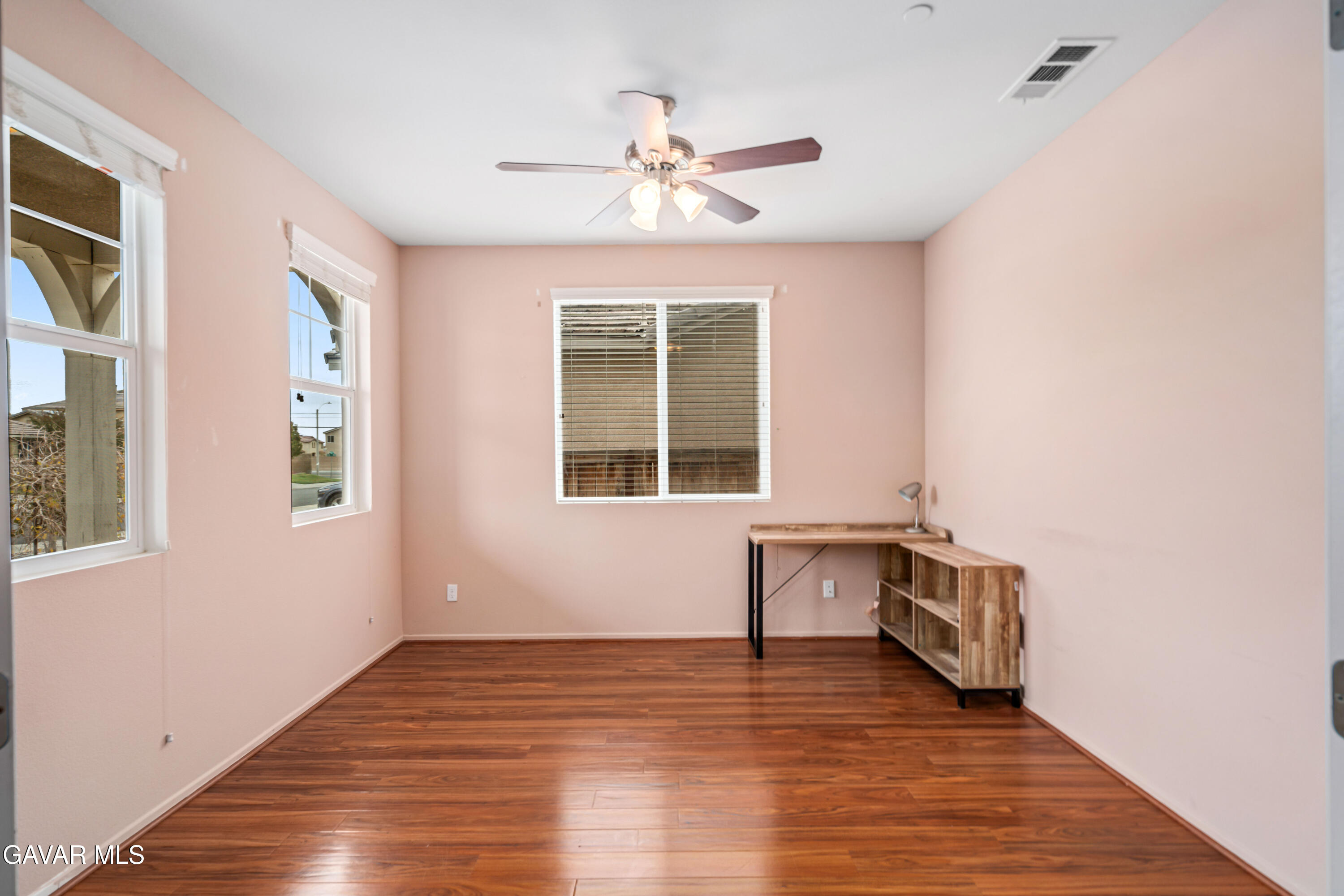 3024 Erica Avenue Rosamond, CA 93560 - Photo 14 of 32 a view of an empty room with wooden floor and a window