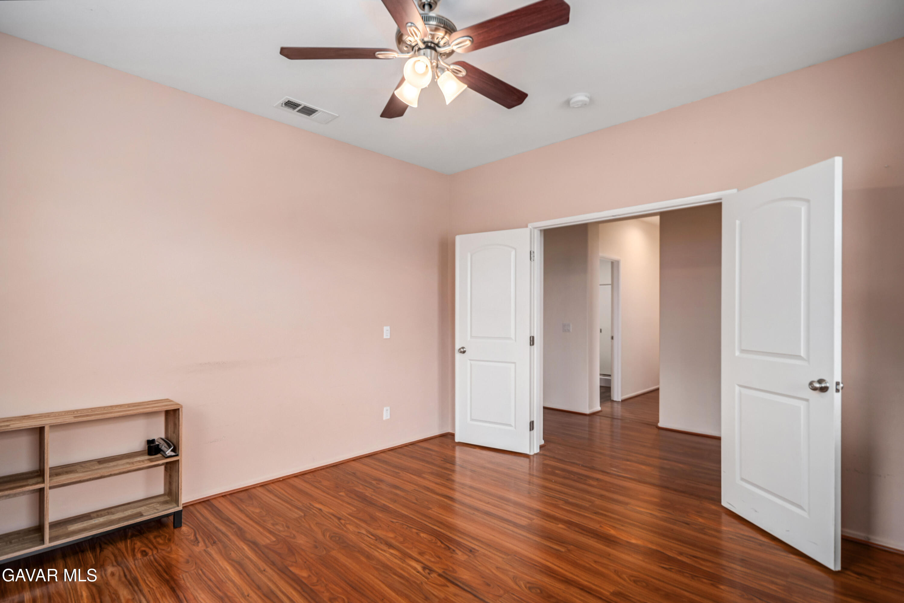 3024 Erica Avenue Rosamond, CA 93560 - Photo 15 of 32 an empty room with wooden floor closet and windows