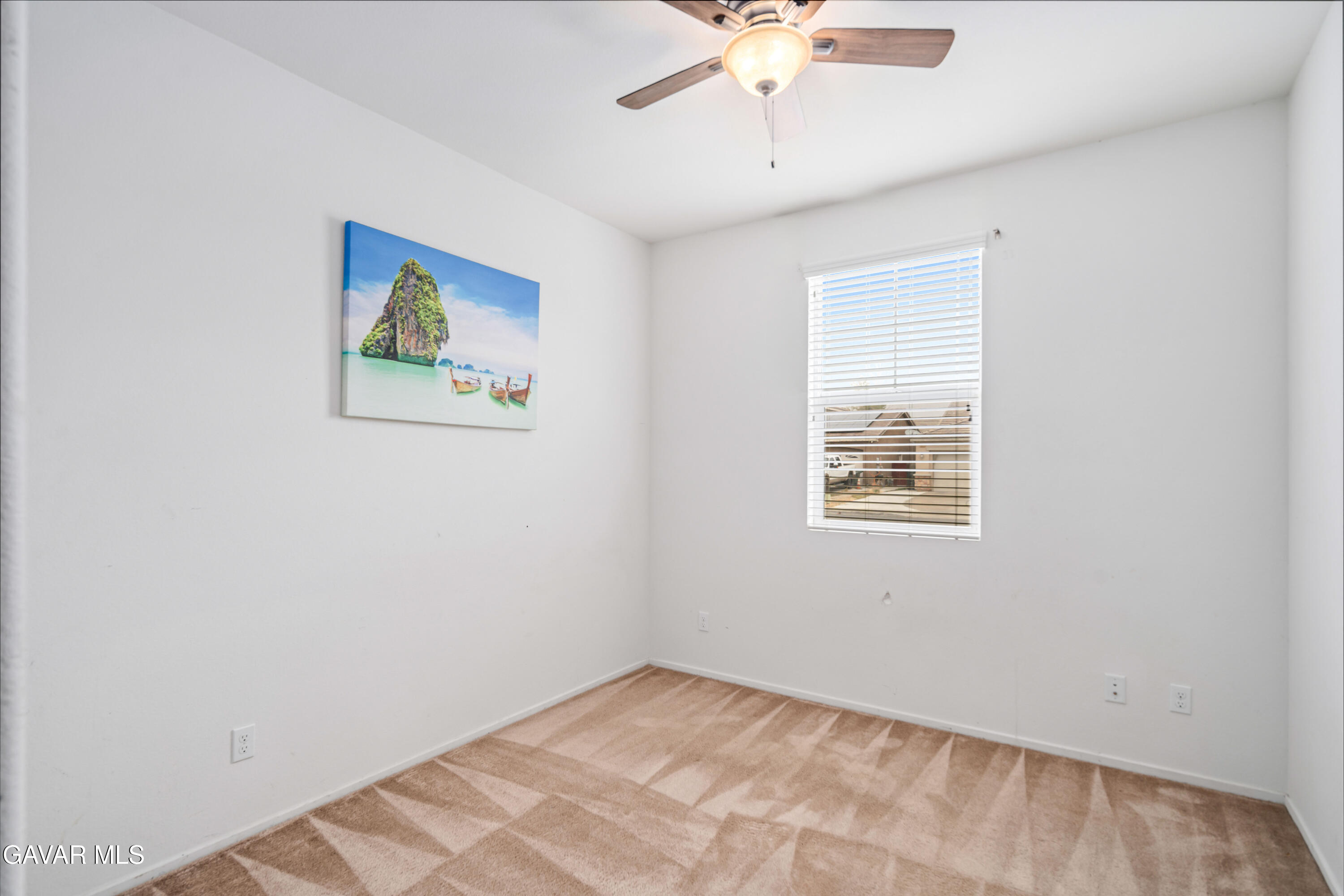 3024 Erica Avenue Rosamond, CA 93560 - Photo 16 of 32 an empty room with a window and a fan