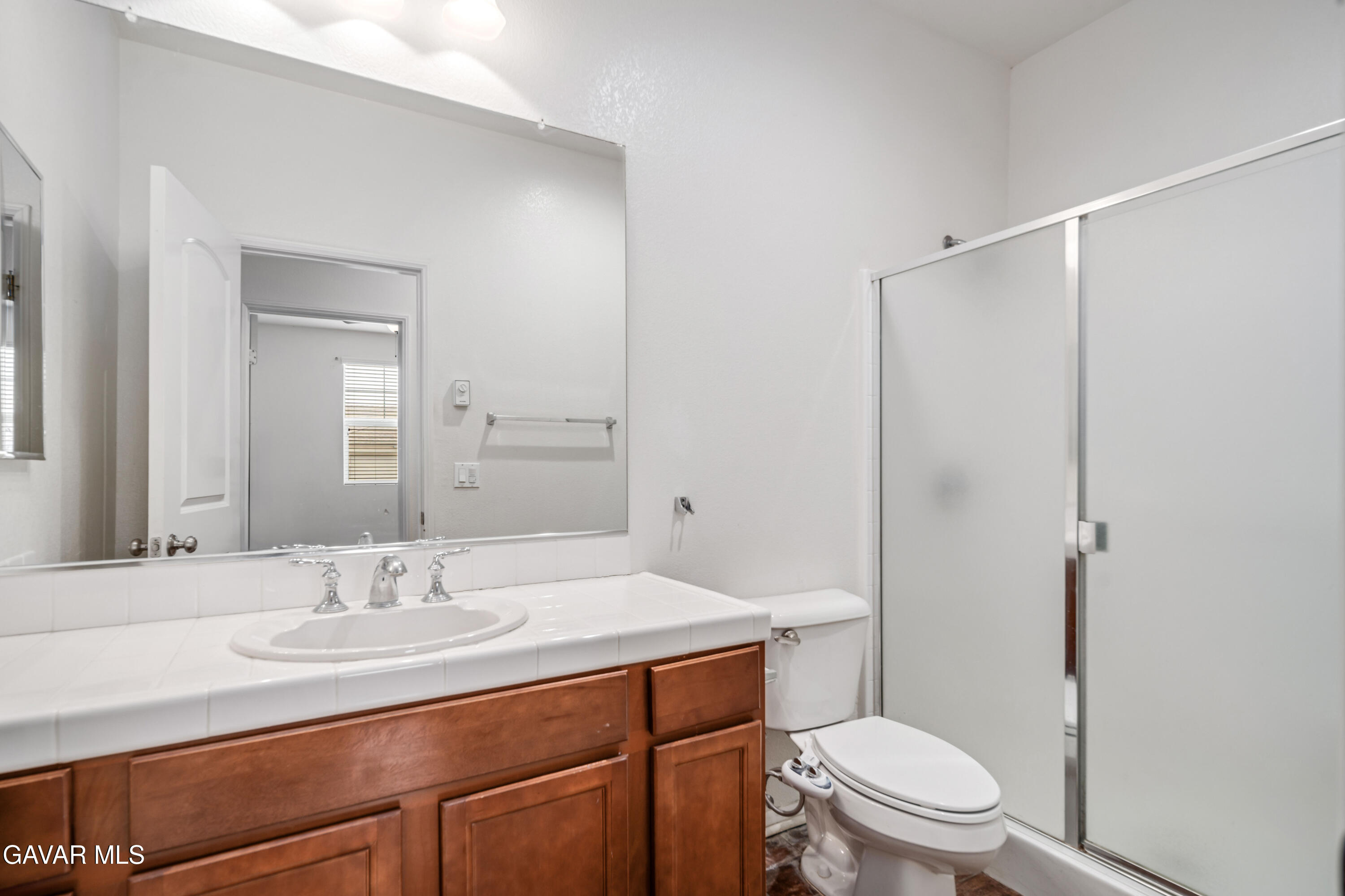 3024 Erica Avenue Rosamond, CA 93560 - Photo 17 of 32 a bathroom with a sink toilet vanity and shower