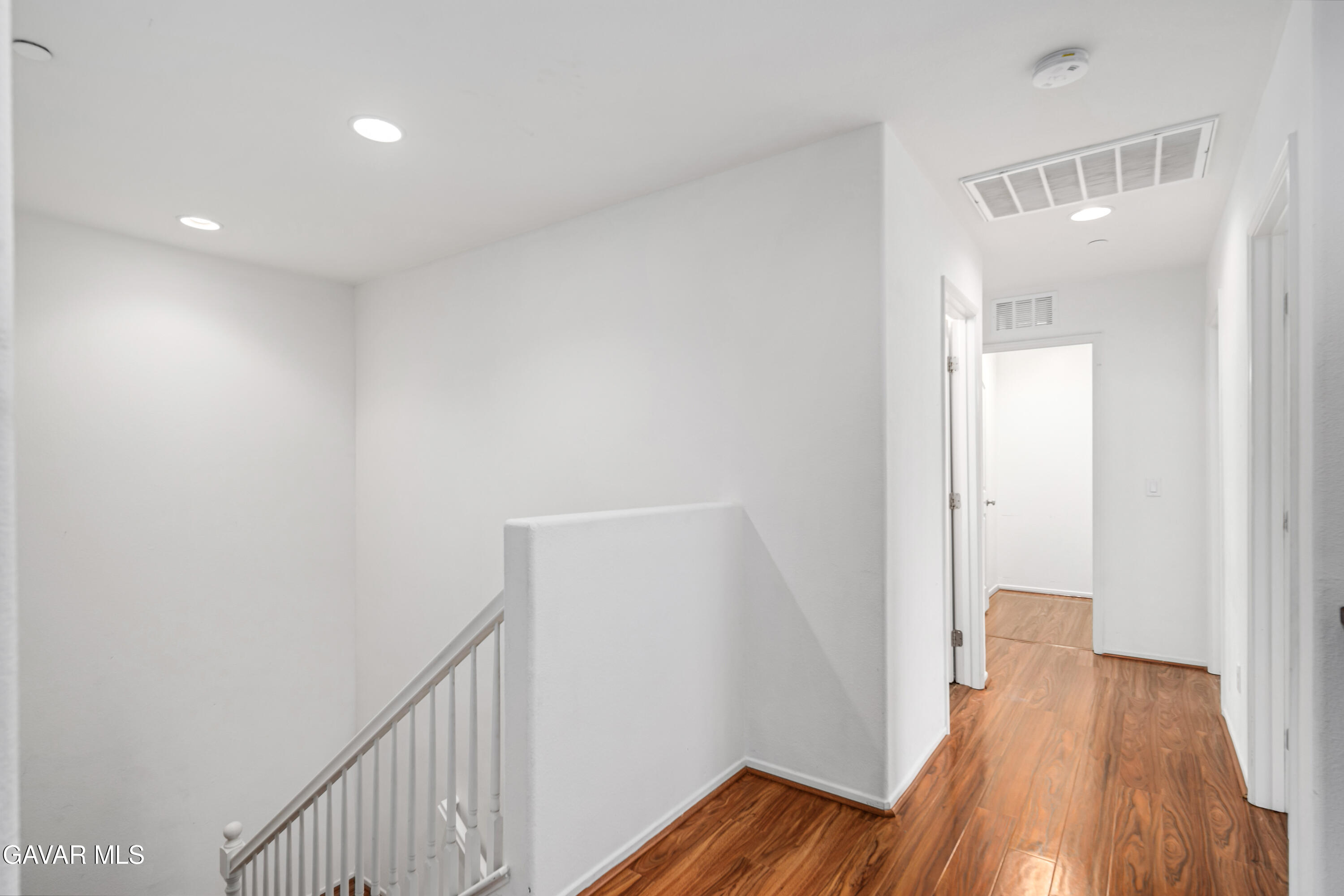 3024 Erica Avenue Rosamond, CA 93560 - Photo 18 of 32 a view of a hallway with wooden floor