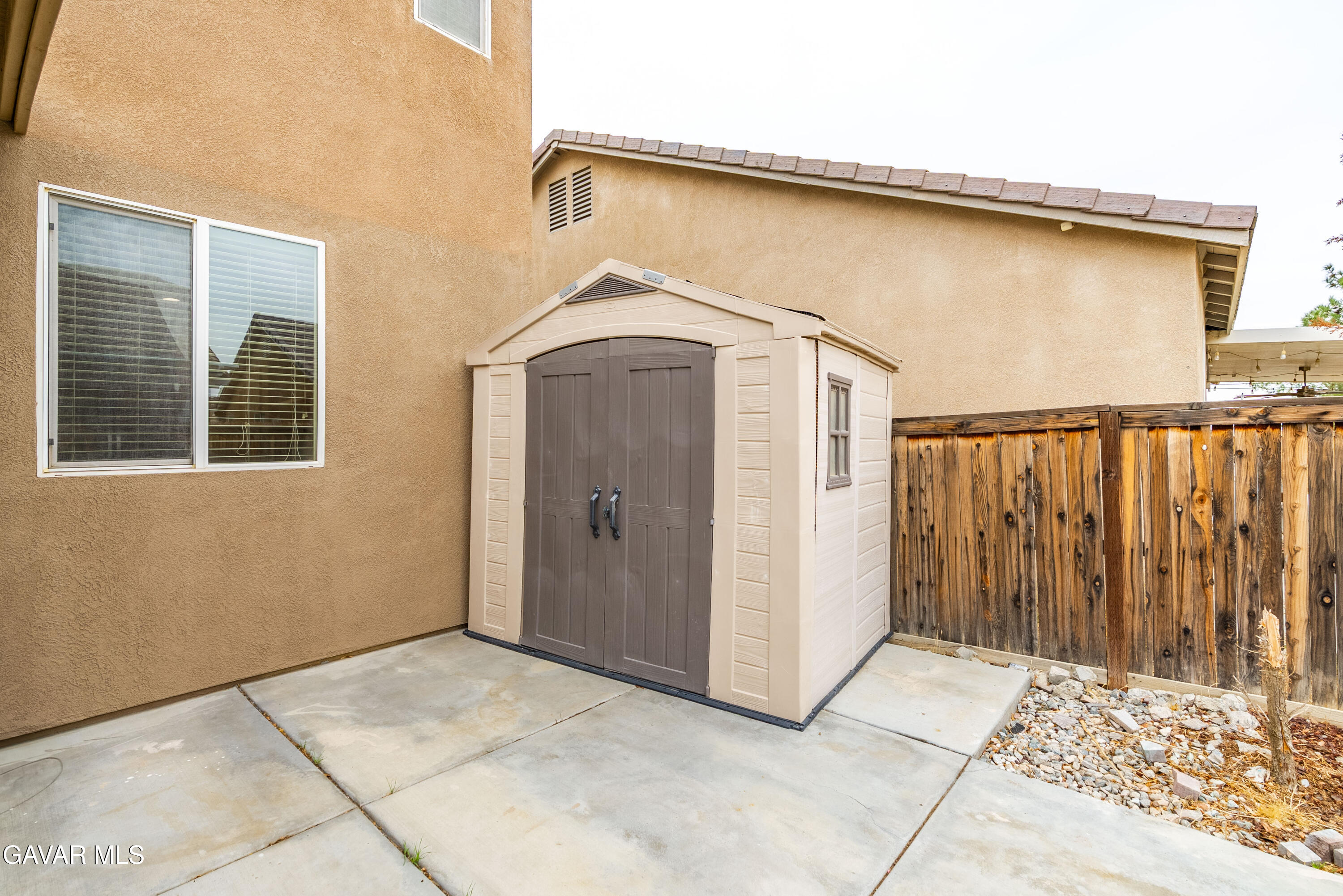 3024 Erica Avenue Rosamond, CA 93560 - Photo 32 of 32 a view of a house with wooden floor and a window