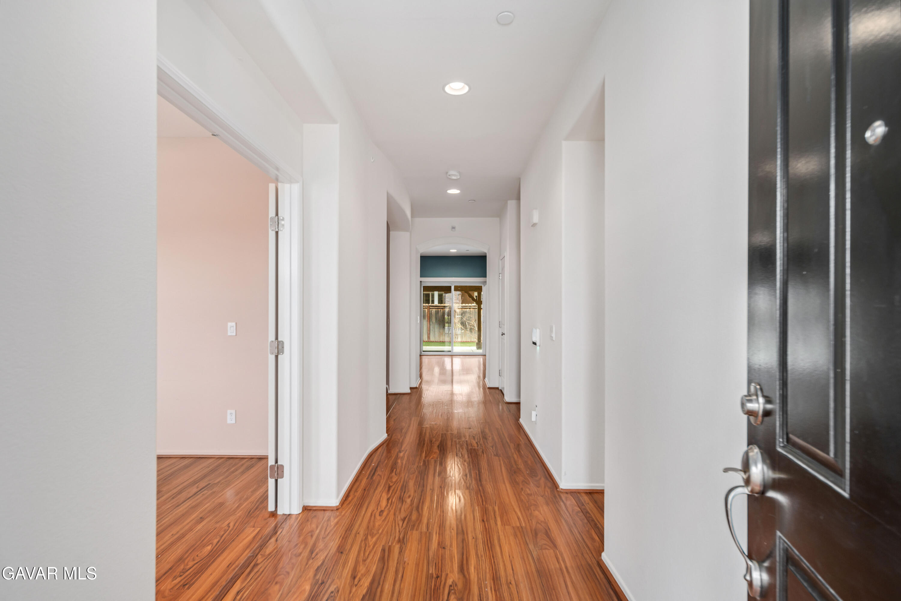 3024 Erica Avenue Rosamond, CA 93560 - Photo 4 of 32 a view of a hallway with wooden floor