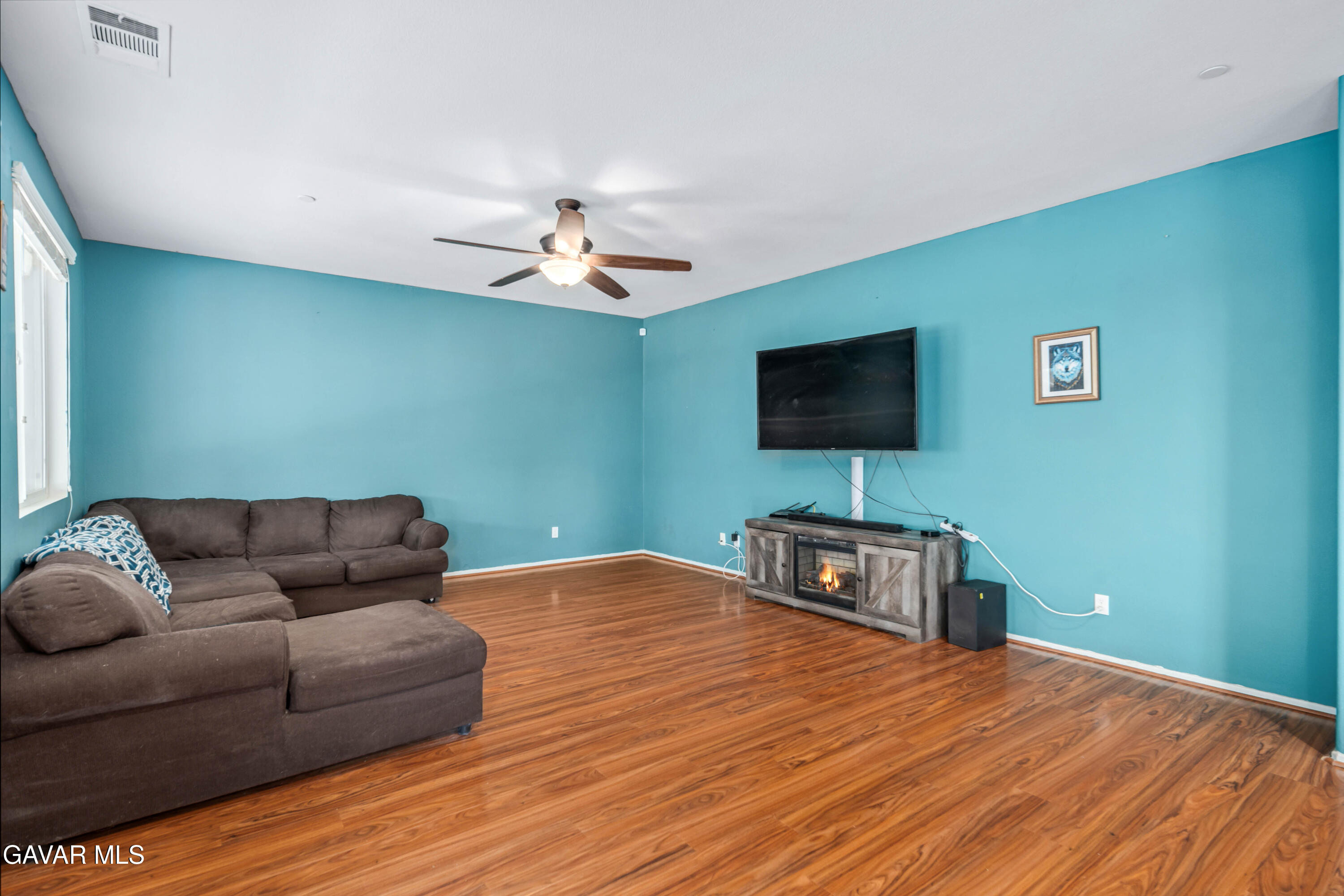 3024 Erica Avenue Rosamond, CA 93560 - Photo 6 of 32 a living room with furniture and a flat screen tv