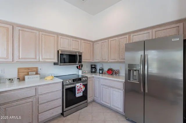a kitchen with a refrigerator sink and cabinets