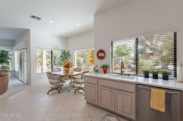 a view of a kitchen with dining table and chairs