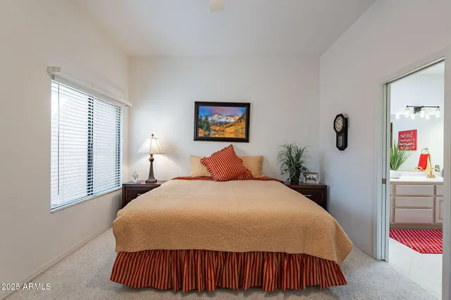 a bedroom with a bed and a painting on the wall