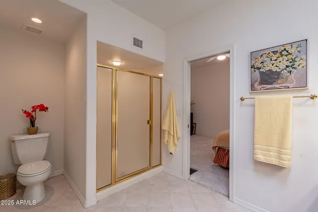 a bathroom with a toilet sink and a shower