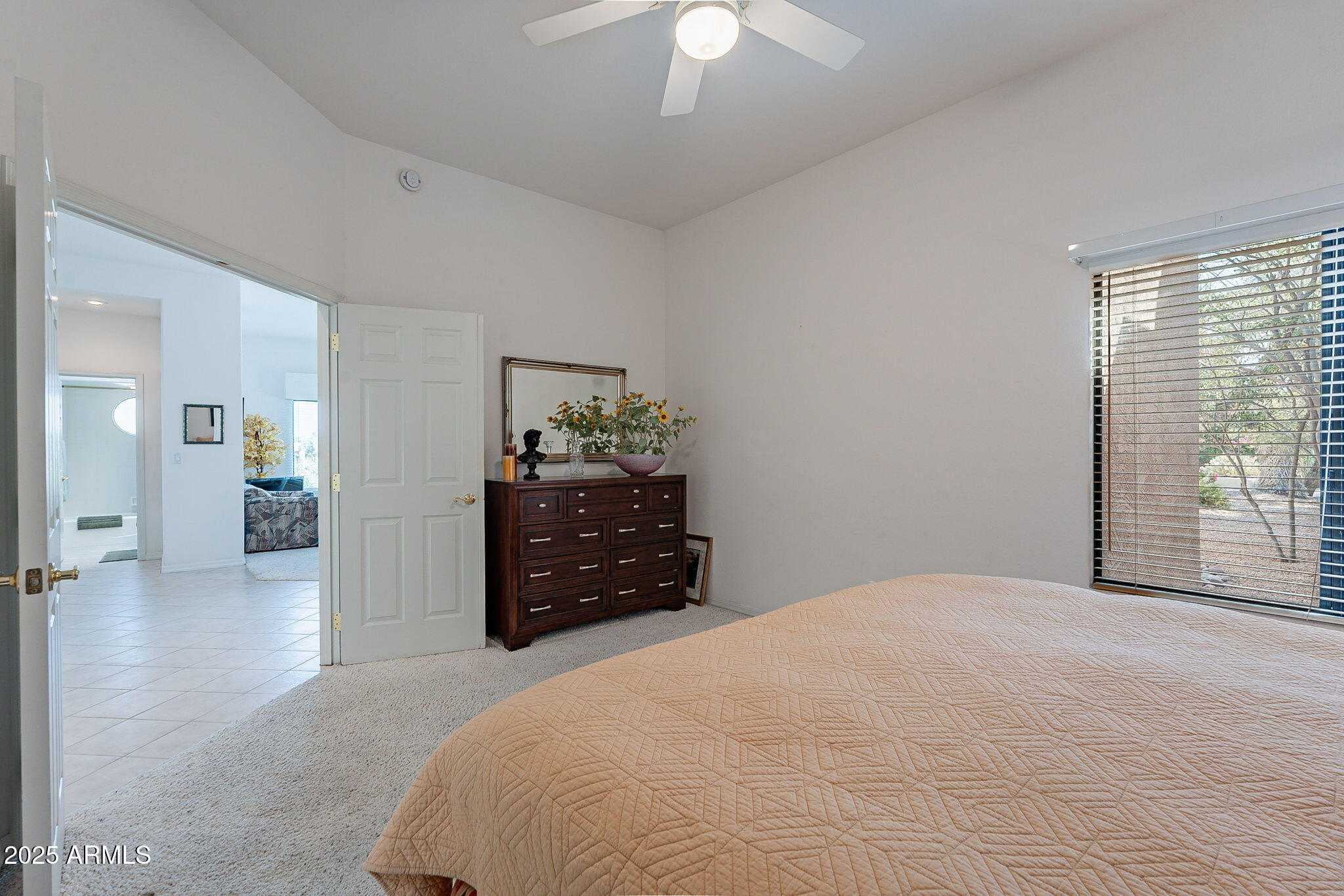 18637 Amarado Circle Rio Verde, AZ 85263 - Photo 21 of 51 a bedroom with a bed and a chandelier