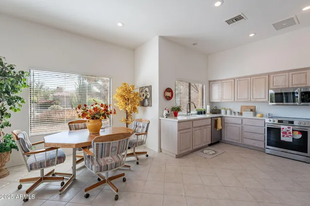 a kitchen with a table and chairs in it