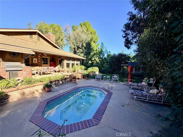 a view of a swimming pool with a patio