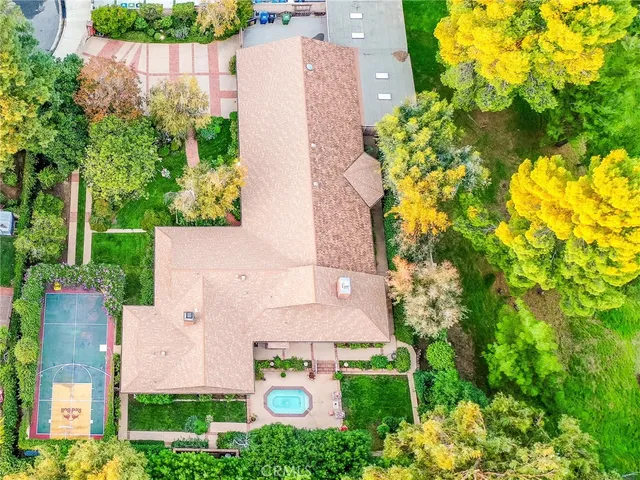 an aerial view of a house with a yard and garden