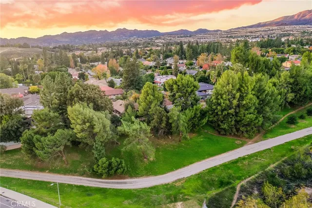 a view of a lush green hillside and a houses
