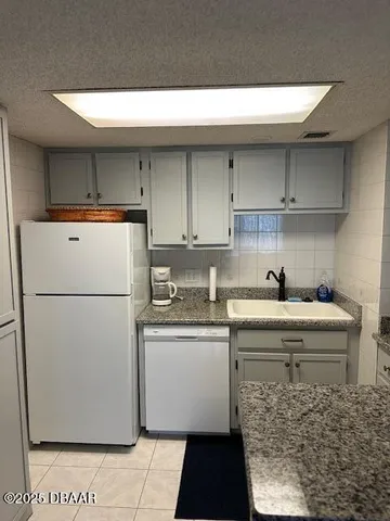 a utility room with cabinets washer and dryer