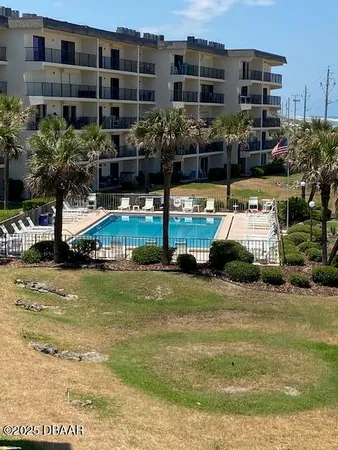 a house view with swimming pool