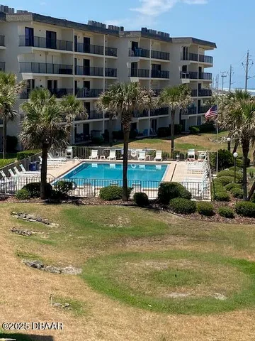a house view with swimming pool