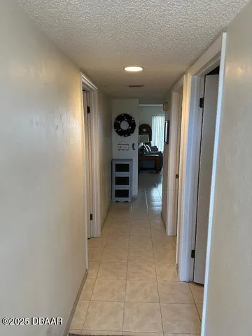 a view of a hallway to closet and a fireplace