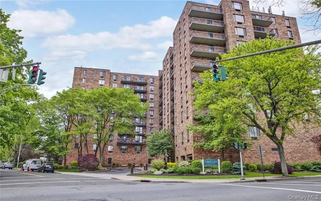 a view of a tall building next to a road