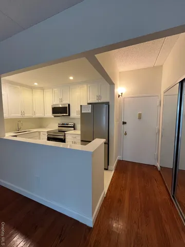 a kitchen with stainless steel appliances a refrigerator and a stove top oven