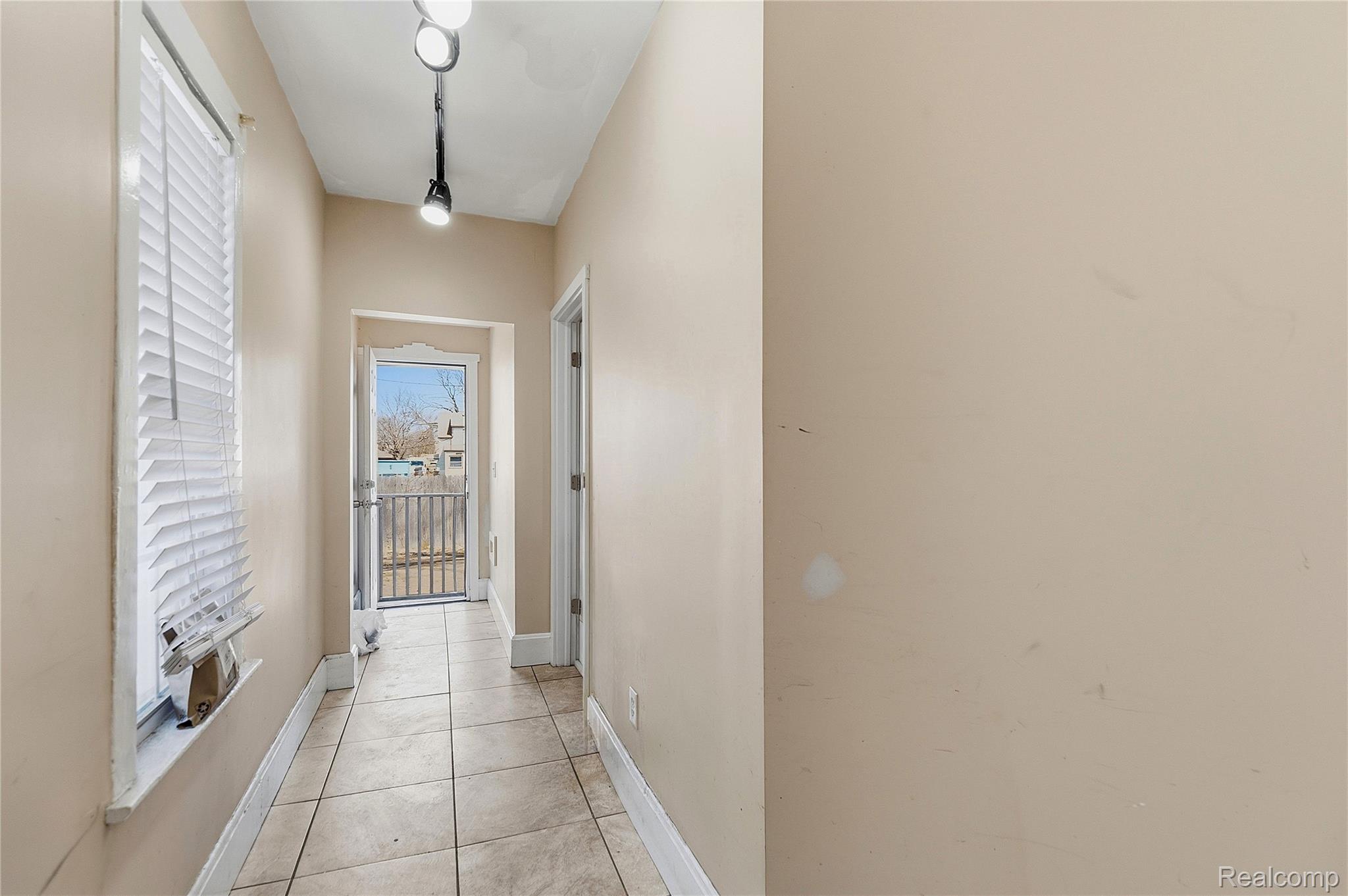11429 East Eight Mile Road Warren, MI 48089 - Photo 18 of 23 Hallway featuring baseboards and light tile patterned floors