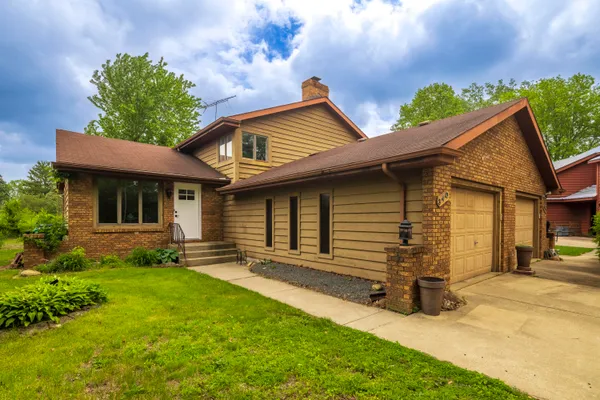 a front view of a house with a yard and porch