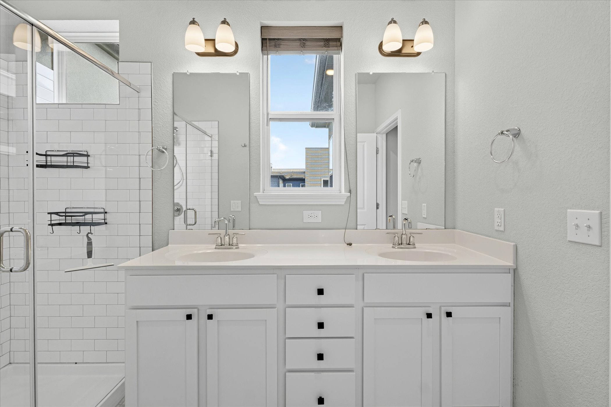 9015 Cattle Baron Path, Unit 1102 Austin, TX 78747 - Photo 14 of 25 Dual vanity with pristine countertops and integrated sinks elevate this bathroom's functionality and appeal.